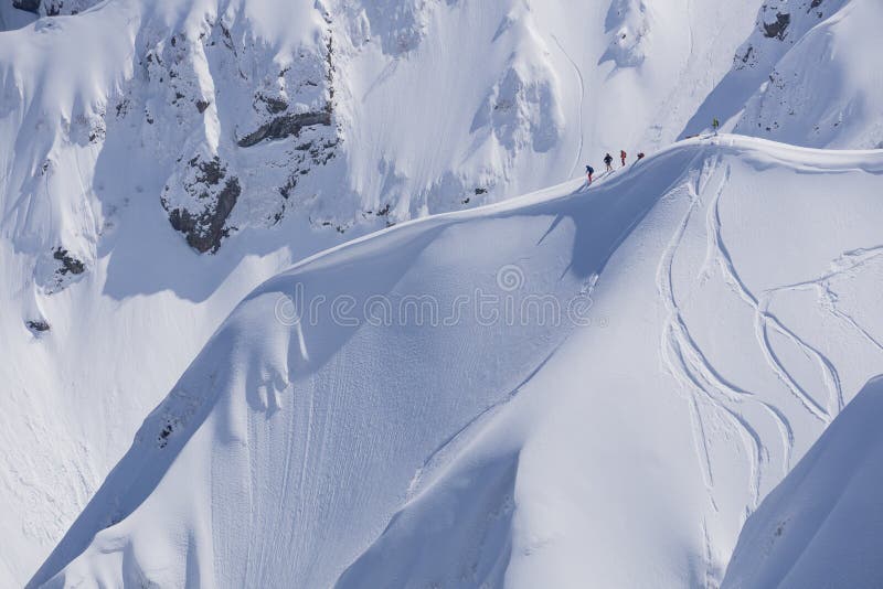 Snowboard freeride, riders and tracks on a mountain slope. Extreme winter sport. Snowboard freeride, riders and tracks on a mountain slope. Extreme winter sport.