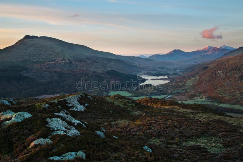 Snowdon (Welsh: Yr Wyddfa, pronounced [əɾ ˈwɨ̞ðva]) is the highest mountain in Wales, at an elevation of 1,085 metres (3,560 ft) above sea level, and the highest point in the British Isles outside the Scottish Highlands. It is located in Snowdonia National Park (Parc Cenedlaethol Eryri) in Gwynedd, and has been described as probably the busiest mountain in Britain.[3] It is designated as a national nature reserve for its rare flora and fauna. The rocks that form Snowdon were produced by volcanoes in the Ordovician period, and the massif has been extensively sculpted by glaciation, forming the pyramidal peak of Snowdon and the arêtes of Crib Goch and Y Lliwedd. The cliff faces on Snowdon, including Clogwyn Du'r Arddu, are significant for rock climbing, and the mountain was used by Edmund Hillary in training for the 1953 ascent of Mount Everest. Snowdon offers some of the best views in Britain. The summit can be reached by a number of well-known paths, and by the Snowdon Mountain Railway, a rack and pinion railway opened in 1896 which carries passengers the 4.7 miles (7.6 km) from Llanberis to the summit station. The summit also houses a cafe called Hafod Eryri, open only when the railway is operating and built in 2006 to replace one built in the 1930s. The railway generally operates to the summit station from Whitsun to October. The daily running schedule depends on weather and customer demand. Snowdon (Welsh: Yr Wyddfa, pronounced [əɾ ˈwɨ̞ðva]) is the highest mountain in Wales, at an elevation of 1,085 metres (3,560 ft) above sea level, and the highest point in the British Isles outside the Scottish Highlands. It is located in Snowdonia National Park (Parc Cenedlaethol Eryri) in Gwynedd, and has been described as probably the busiest mountain in Britain.[3] It is designated as a national nature reserve for its rare flora and fauna. The rocks that form Snowdon were produced by volcanoes in the Ordovician period, and the massif has been extensively sculpted by glaciation, forming the pyramidal peak of Snowdon and the arêtes of Crib Goch and Y Lliwedd. The cliff faces on Snowdon, including Clogwyn Du'r Arddu, are significant for rock climbing, and the mountain was used by Edmund Hillary in training for the 1953 ascent of Mount Everest. Snowdon offers some of the best views in Britain. The summit can be reached by a number of well-known paths, and by the Snowdon Mountain Railway, a rack and pinion railway opened in 1896 which carries passengers the 4.7 miles (7.6 km) from Llanberis to the summit station. The summit also houses a cafe called Hafod Eryri, open only when the railway is operating and built in 2006 to replace one built in the 1930s. The railway generally operates to the summit station from Whitsun to October. The daily running schedule depends on weather and customer demand.