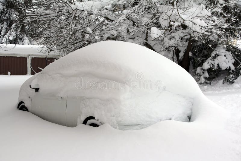 A completely snowed white car