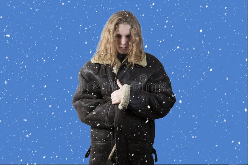 Snowfall. Winter. A person freezes in cold weather. A man in a winter jacket is standing on the street royalty free stock photos