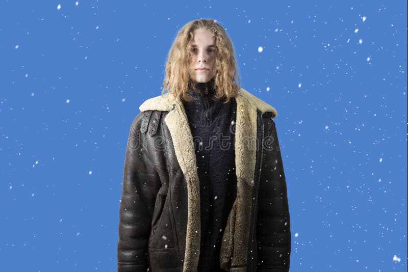 Snowfall. Winter. A person freezes in cold weather. A man in a winter jacket is standing on the street royalty free stock photos