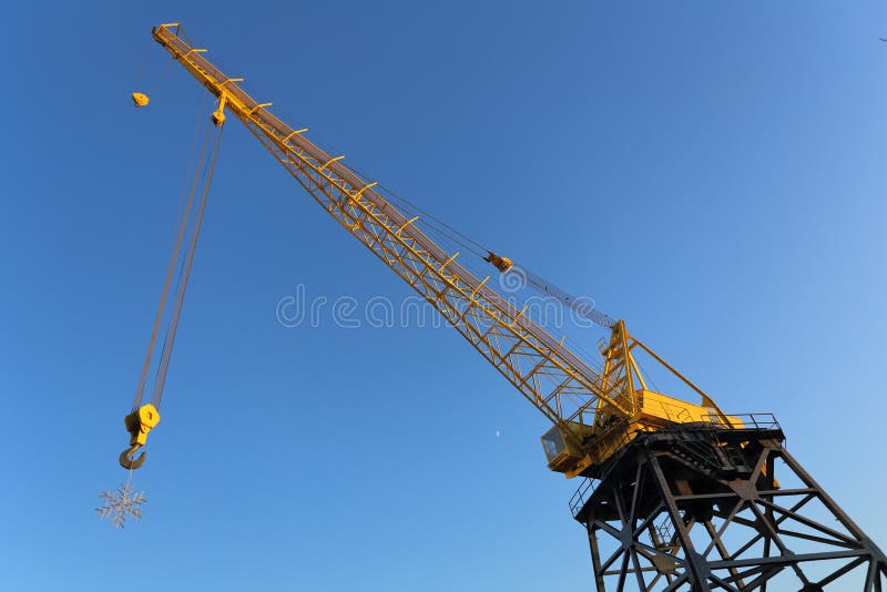 Snowflake is suspended on a hook of crane