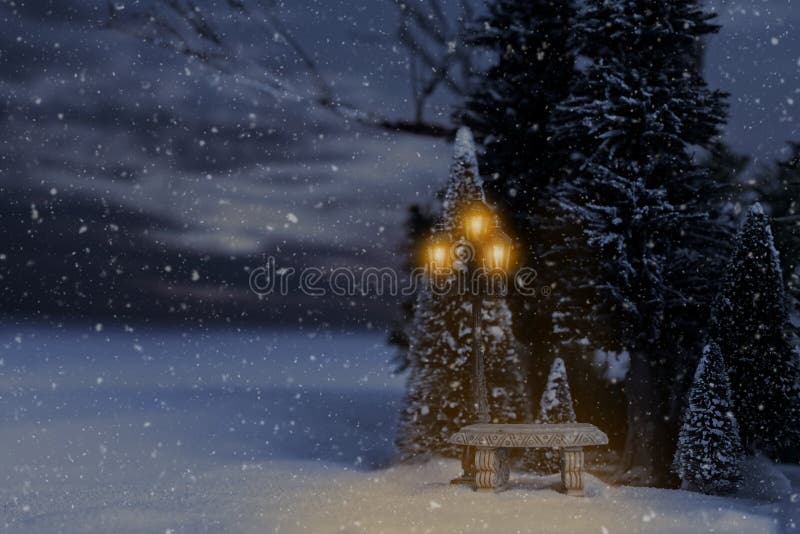 Snowing winter landscape with bench and lamp post