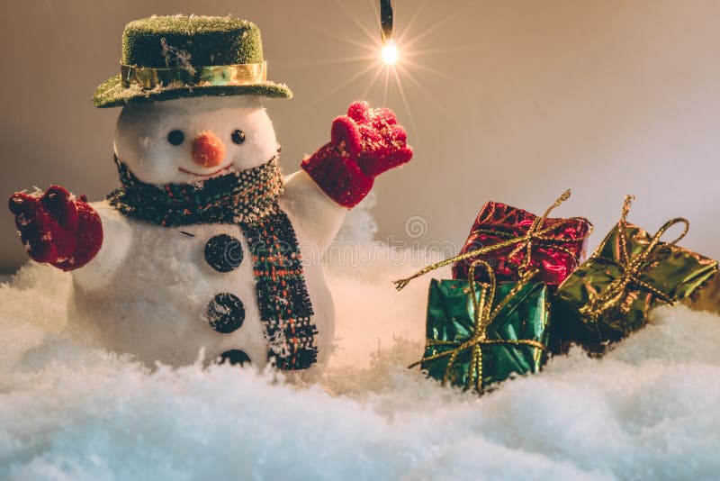 Snowman and light bulb stand among pile of snow at silent night, Merry christmas and Happy new year night.