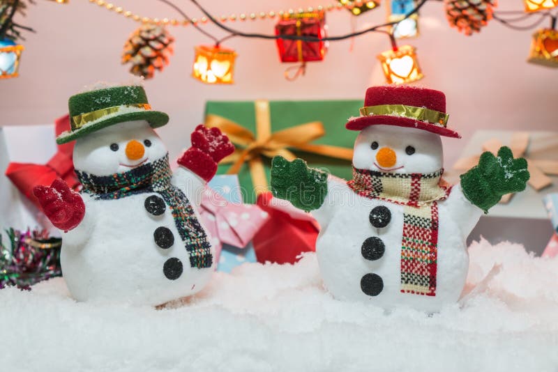 Snowman stand among pile of snow at silent night with a light bulb,Merry christmas and new year night.