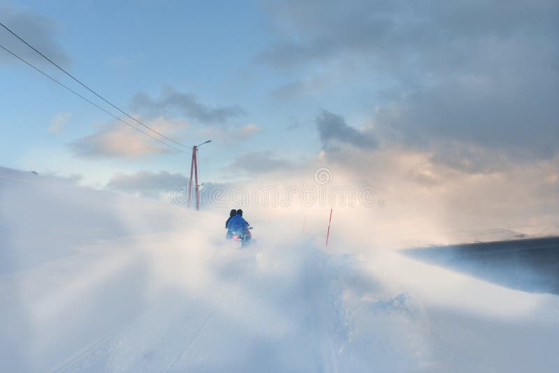 Snowscooter driving through snowdrift