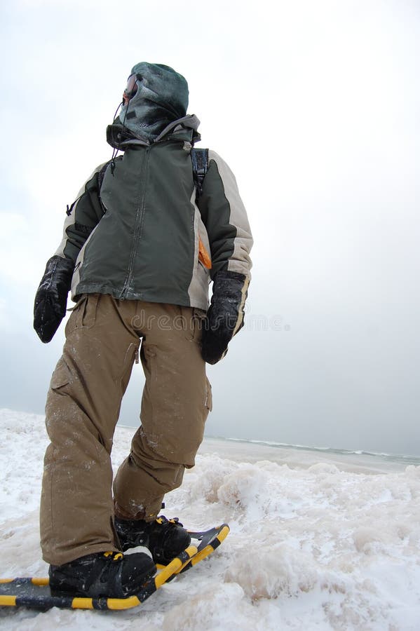 A man snowshoeing on a frozen lake in the middle of winter. Adventurer adventure stock images, royalty-free photos and pictures
