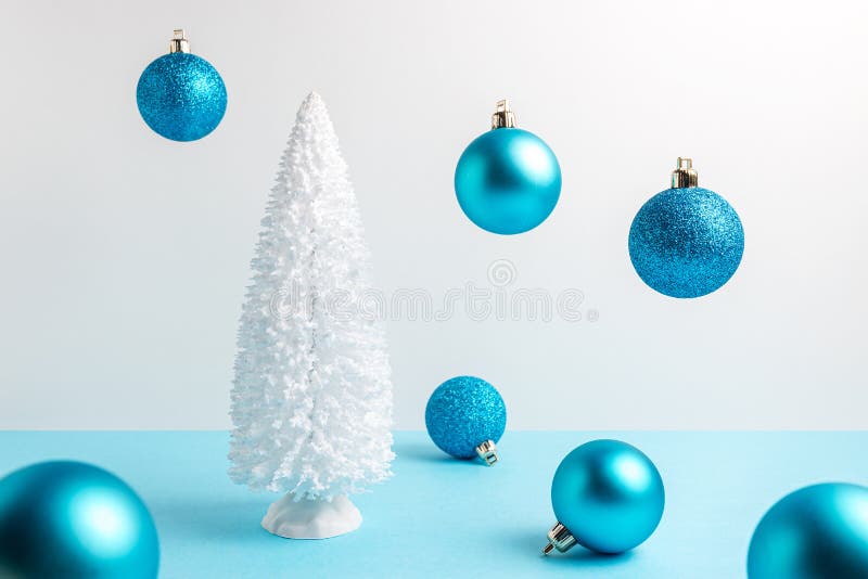 Snowy Christmas Tree with Christmas Decoration on Blue Table. Christmas