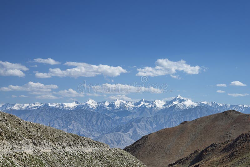 Snowy mountain range and road on edge