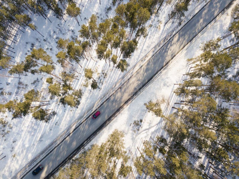 Snowy road with a moving car in winter