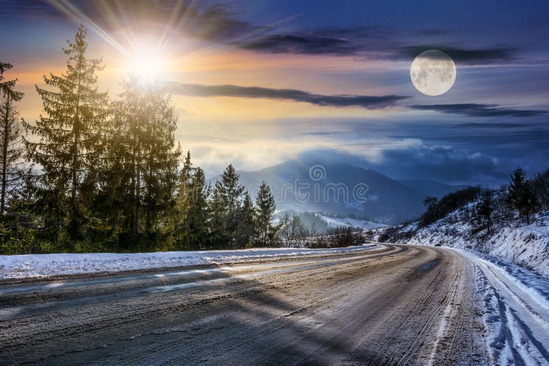 Snowy road through spruce forest in mountains