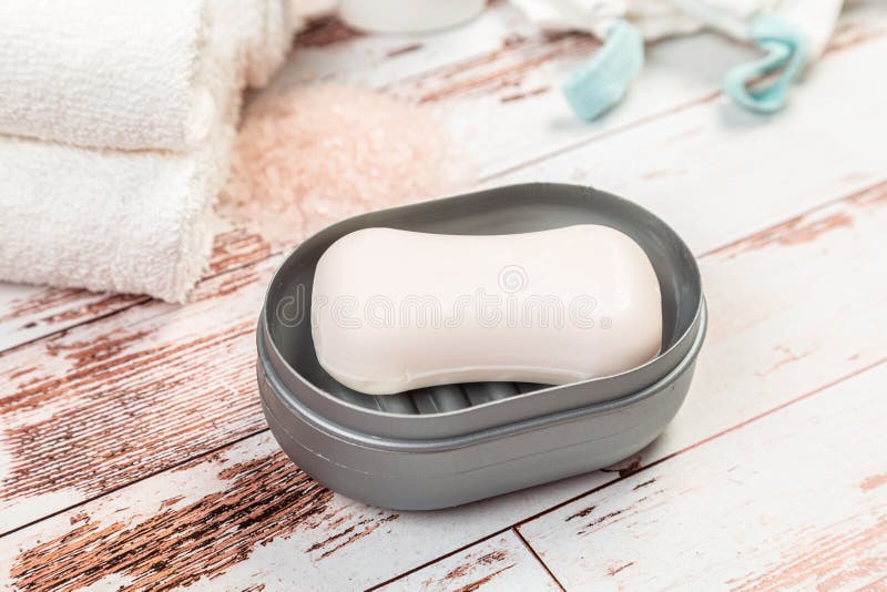Soap on a Gray Plastic Soap Dish, on a White Wooden Table Stock Photo