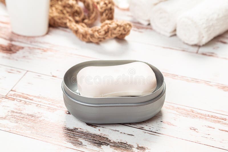 Soap on a Gray Plastic Soap Dish, on a White Wooden Table Stock Photo