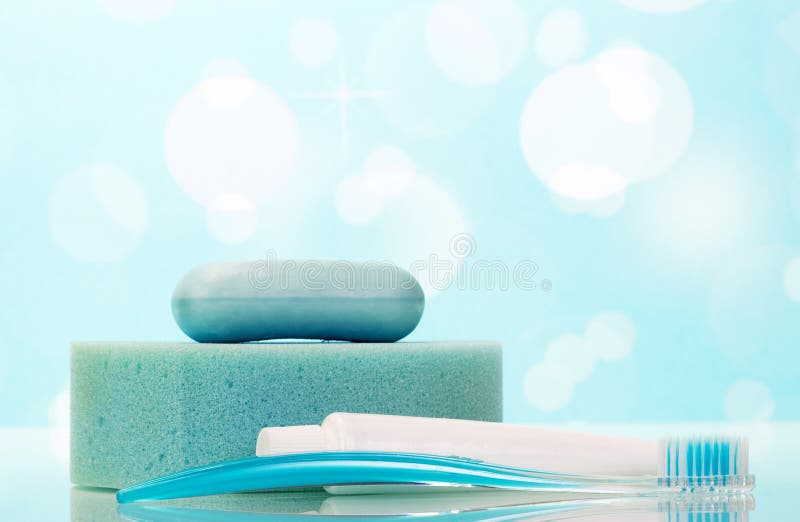 Soap, tooth paste and brush in the bathroom on the abstract blue background. Soap, tooth paste and brush in the bathroom on the abstract blue background.