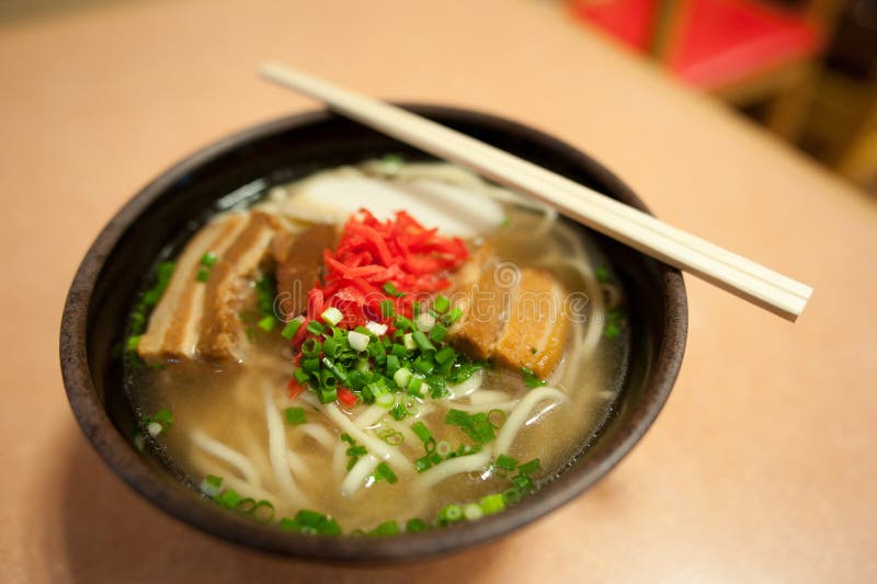 Okinawa soba (æ²–ç¸„ãã°) is a type of noodle soup eaten in Okinawa. In Okinawa, it is sometimes simply called soba or suba, although it is different from buckwheat noodles known as soba in the rest of Japan. The thick wheat noodles resemble udon, while the soup is more similar to that of ramen. The noodles tend to have a circular cross section in the Yaeyama Islands, and tend to be slightly flat in the rest of the Okinawan archipelago. It is served in a broth flavored with konbu (edible seaweed), katsuobushi flakes and pork. Standard toppings are kamaboko (fish cake), sliced scallion and a thick slice of stewed pork belly (ä¸‰æžšè‚‰ san-mai niku) or boneless pork ribs (ã‚½ãƒ¼ã‚­ sÅki?), and usually garnished with beni shoga (pickled ginger). For extra spice, diners can add a few drops of kÅrÄ“gÅ«su (é«˜éº—èƒ¡æ¤’, ã‚³ãƒ¼ãƒ¬ãƒ¼ã‚°ãƒ¼ã‚¹ Korean pepper), which consists of chile peppers soaked in awamori rice liquor. Okinawa soba (æ²–ç¸„ãã°) is a type of noodle soup eaten in Okinawa. In Okinawa, it is sometimes simply called soba or suba, although it is different from buckwheat noodles known as soba in the rest of Japan. The thick wheat noodles resemble udon, while the soup is more similar to that of ramen. The noodles tend to have a circular cross section in the Yaeyama Islands, and tend to be slightly flat in the rest of the Okinawan archipelago. It is served in a broth flavored with konbu (edible seaweed), katsuobushi flakes and pork. Standard toppings are kamaboko (fish cake), sliced scallion and a thick slice of stewed pork belly (ä¸‰æžšè‚‰ san-mai niku) or boneless pork ribs (ã‚½ãƒ¼ã‚­ sÅki?), and usually garnished with beni shoga (pickled ginger). For extra spice, diners can add a few drops of kÅrÄ“gÅ«su (é«˜éº—èƒ¡æ¤’, ã‚³ãƒ¼ãƒ¬ãƒ¼ã‚°ãƒ¼ã‚¹ Korean pepper), which consists of chile peppers soaked in awamori rice liquor.