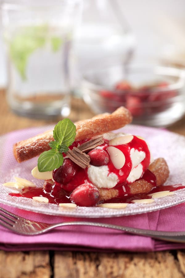 Fan-shaped puff pastries with cream, cranberries and syrup. Fan-shaped puff pastries with cream, cranberries and syrup