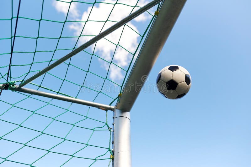 Soccer Ball Flying Into Football Goal Net Over Sky