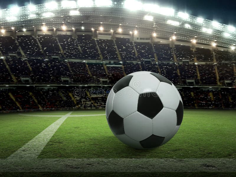Soccer ball on green stadium, arena in night illuminated bright spotlights royalty free stock photography Soccer ball on green stadium, arena in night illuminated bright spotlights royalty free stock photography