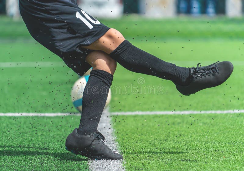 Soccer boy training kicking the ball in soccer training field stock photography Soccer boy training kicking the ball in soccer training field stock photography