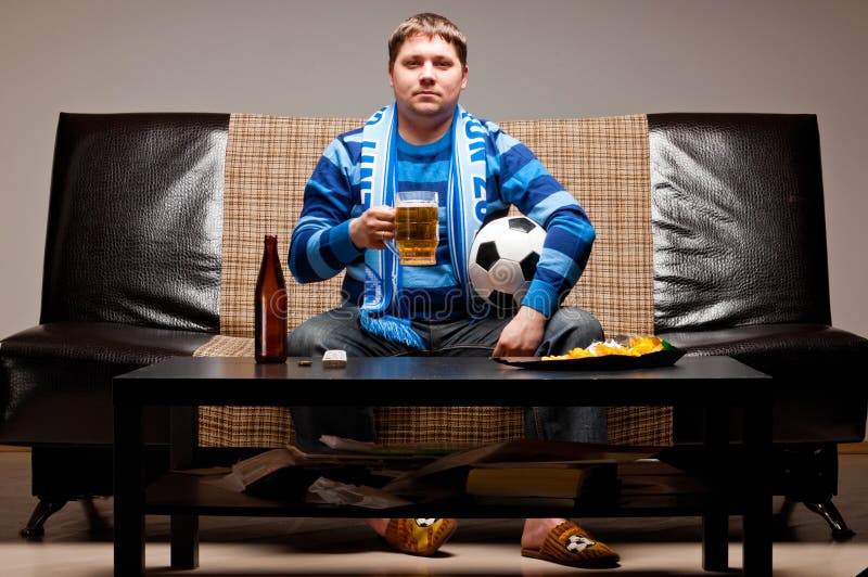 Soccer fan on sofa stock photo. Image of lager, chair 19561896