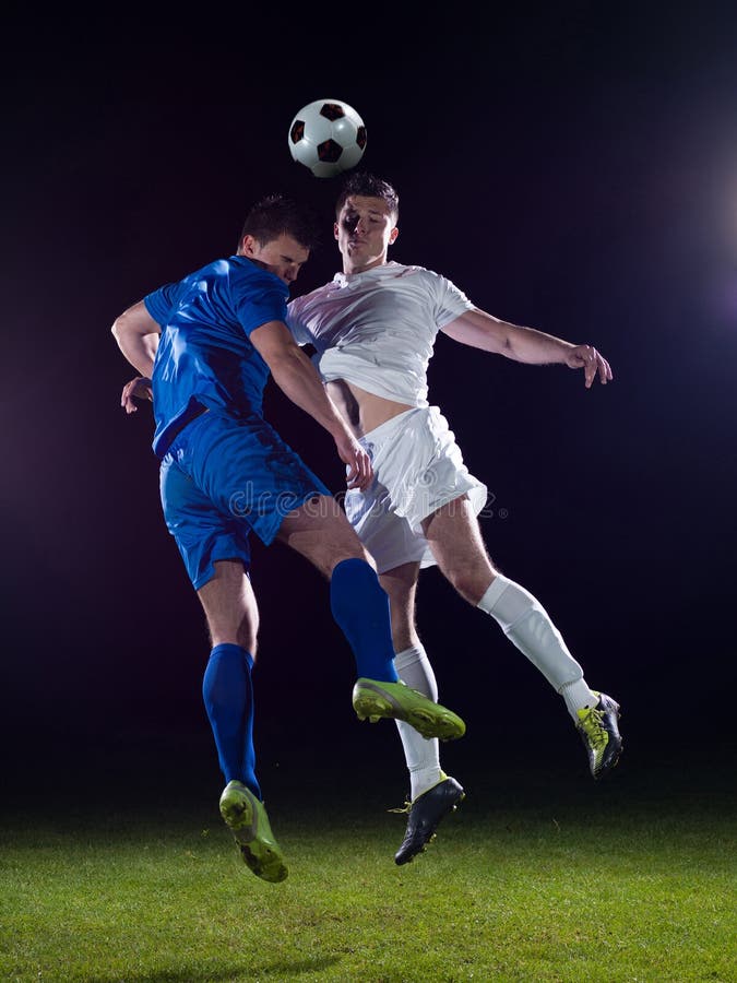 Free Stock Photo of Two footballers are fighting for the ball on the  football field
