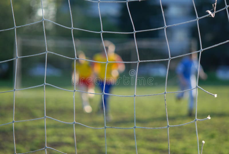 Soccer players in front of net