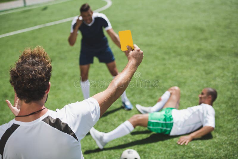 Soccer referee showing yellow card to players during game royalty free stock photos Soccer referee showing yellow card to players during game royalty free stock photos
