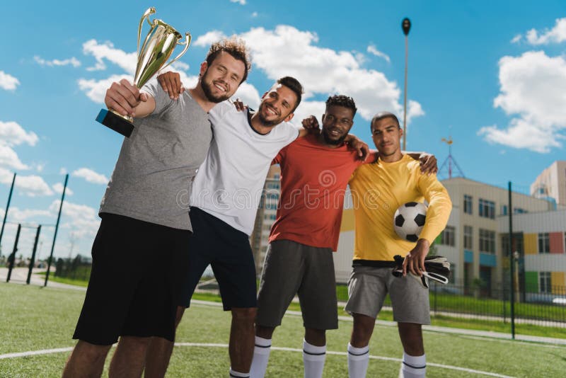Soccer Team with Goblet Standing on Soccer Pitch after Game Stock Photo ...