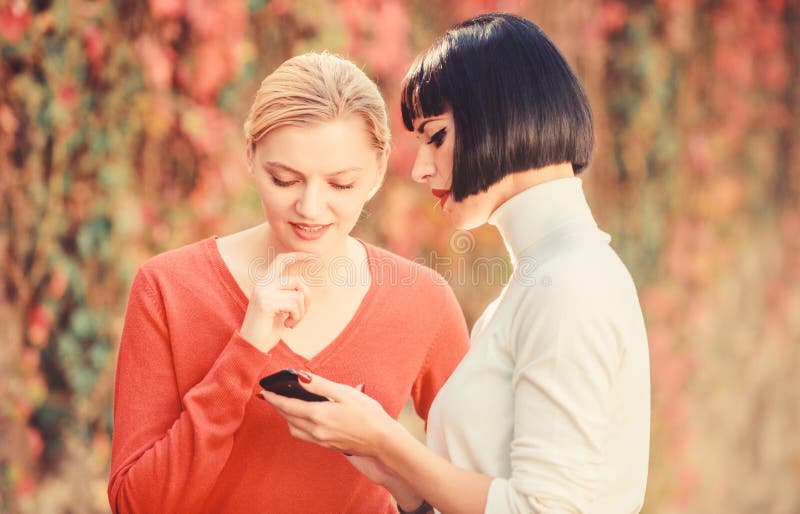 Social network. just look at this. 3g 4g mobile internet surfing. digital marketing two happy women look in phone. buy royalty free stock photo Social network. just look at this. 3g 4g mobile internet surfing. digital marketing two happy women look in phone. buy royalty free stock photo