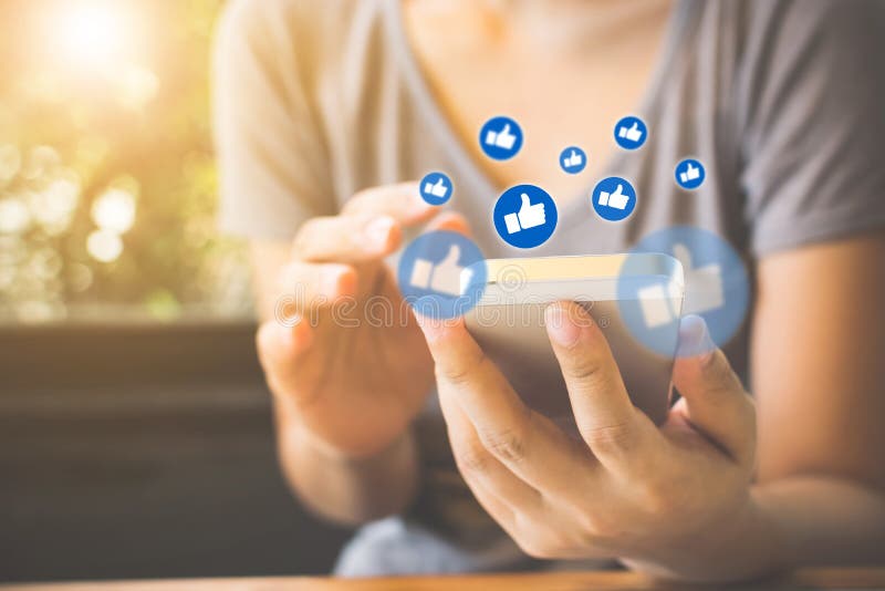 Social network sharing and commenting in the online community, Woman hand holding smartphone and using application social media stock images Social network sharing and commenting in the online community, Woman hand holding smartphone and using application social media stock images