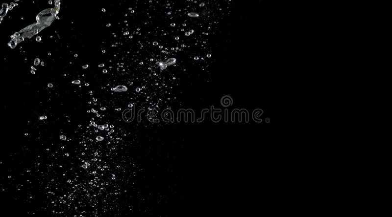 Soda water splashing drop in black background. Soda water bubbles splashing and floating drop in black background represent sparkling and refreshing