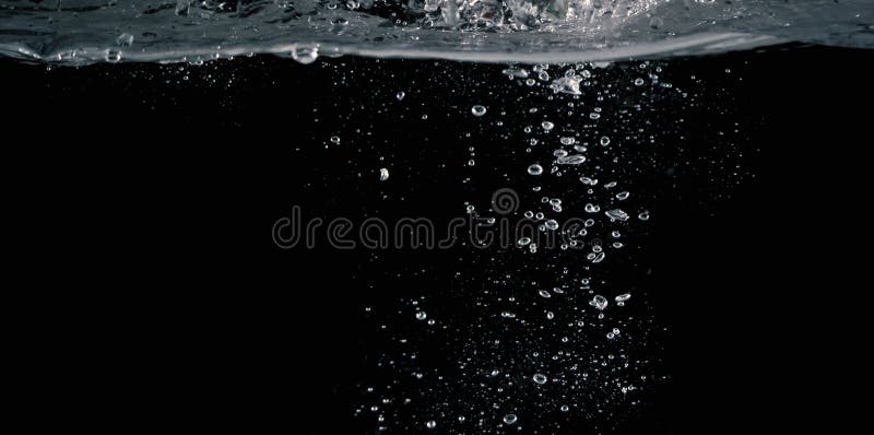 Soda water splashing drop in black background royalty free stock photo