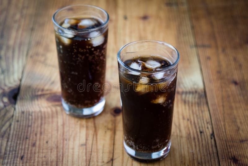 Soda glass whit ice cubes on wooden table. Soda glass whit ice cubes on wooden table