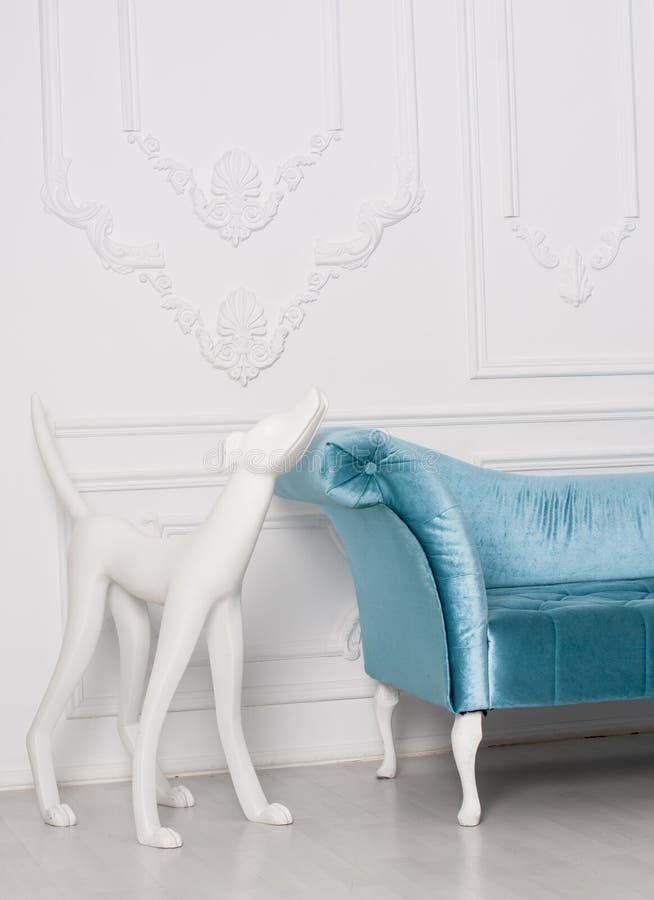 Sofa armrest with white sculpture of dog