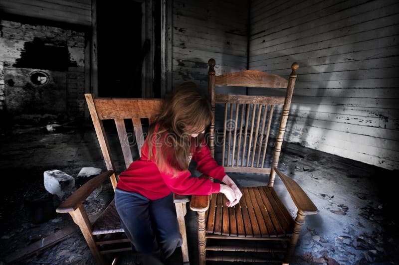 A woman in a desolate room hanging her head over an empty chair. Concept for grief after losing a loved one. A woman in a desolate room hanging her head over an empty chair. Concept for grief after losing a loved one.