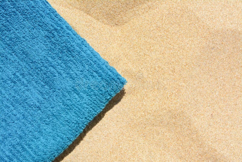 Soft Blue Beach Towel on Sand, Top View. Space for Text Stock Photo