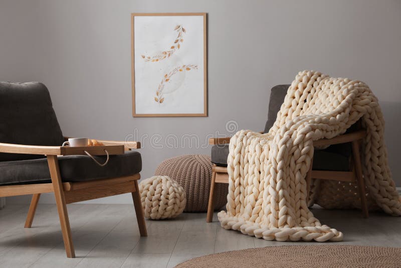 Soft Chunky Knit Blanket on Armchair in Room. Interior Design Stock