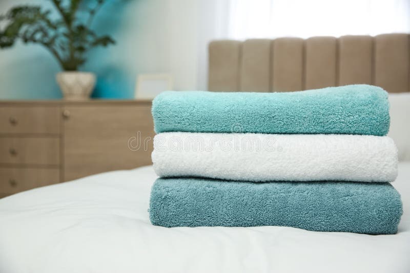 Soft clean towels on bed stock image. Image of cloth 194106993