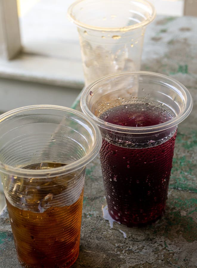 Soft Drink and Ice in the Disposable Plastic Glasses Stock Image