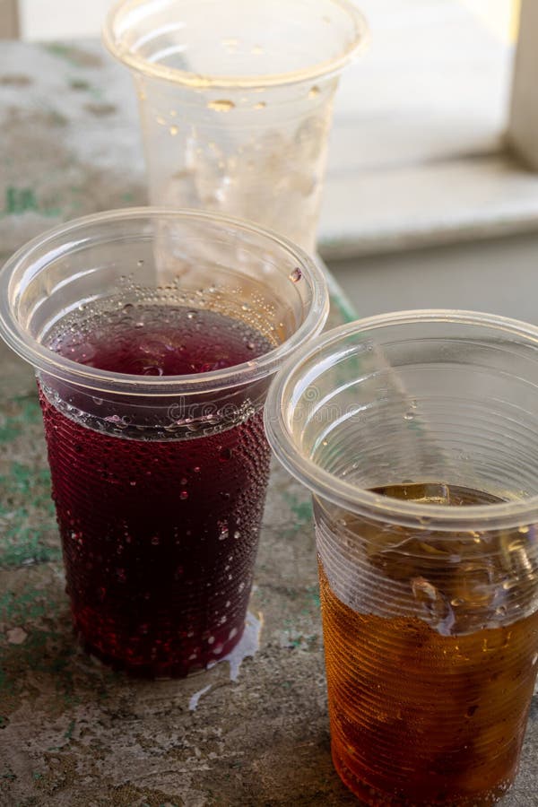 Soft Drink and Ice in the Disposable Plastic Glasses Stock Image