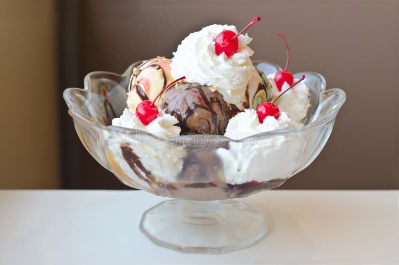 Soft focus of Ice cream sundae in big bowl. On white table royalty free stock image Soft focus of Ice cream sundae in big bowl. On white table royalty free stock image
