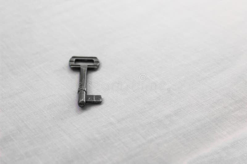Soft focus old rustic key iron material on white sheet surface simple background space royalty free stock images Soft focus old rustic key iron material on white sheet surface simple background space royalty free stock images