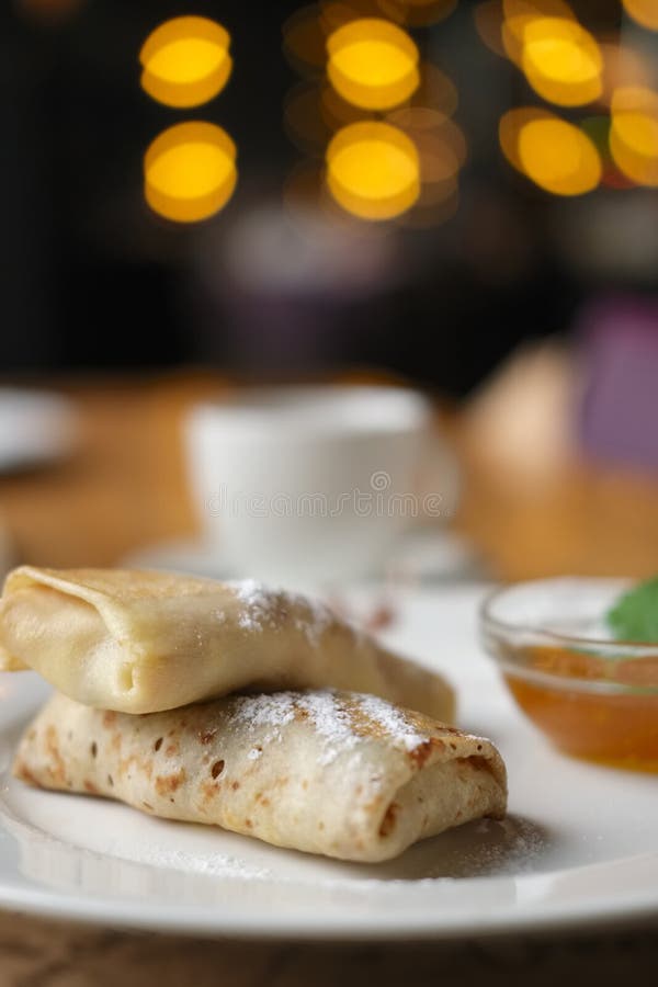 Thin Pancakes with Jam and Cup of Coffee. Breakfast at a Cafe Stock