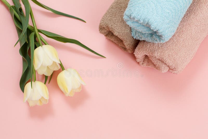 Soft terry towels with flowers on a pink background stock images