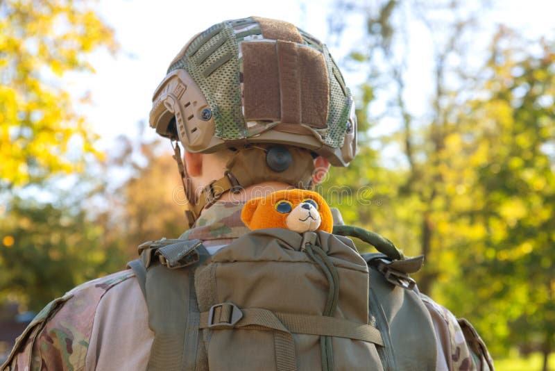 Soft Toy in a Backpack on the Back of a Soldier of Ukraine Stock Photo