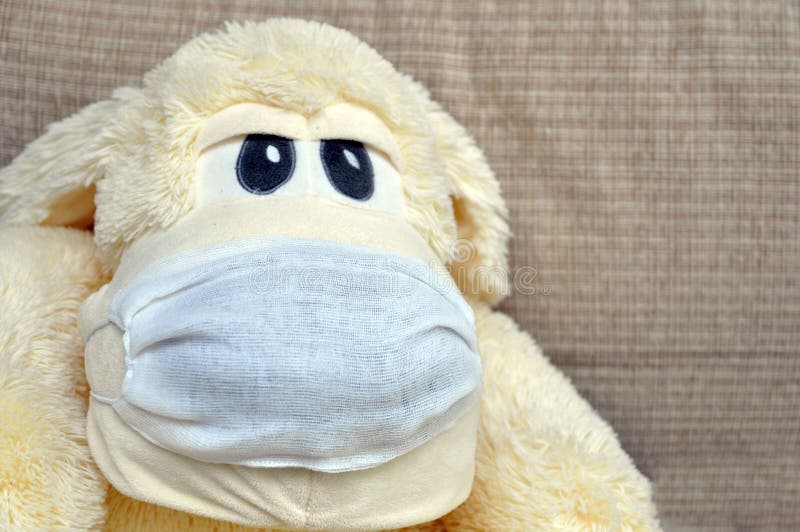 Soft Toy Dog with a Gauze Medical Mask Against the Virus. Coronavirus Protection Concept Stock