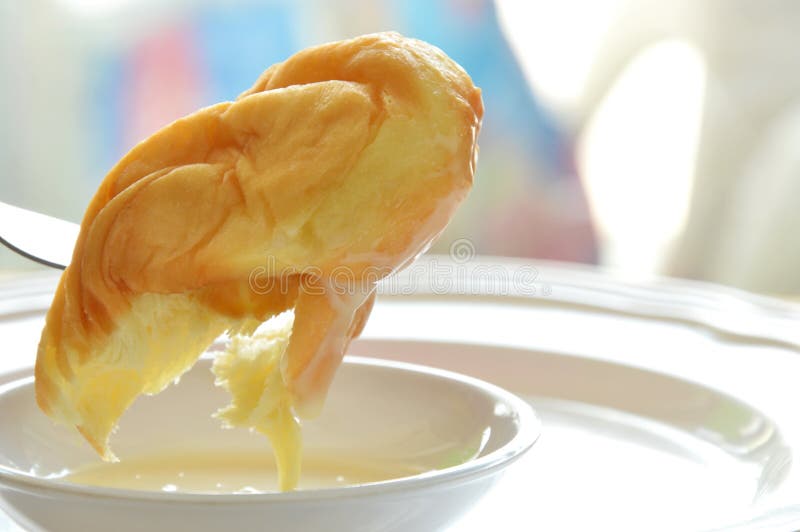 Soft Twist Bread Dipping Sweetened Condensed Milk Stab in Fork Stock