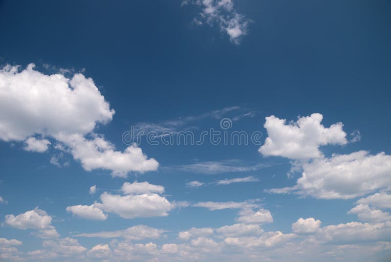 Soft white clouds against dark blue sky. Serene beach atmosphere stock images, royalty-free photos and pictures