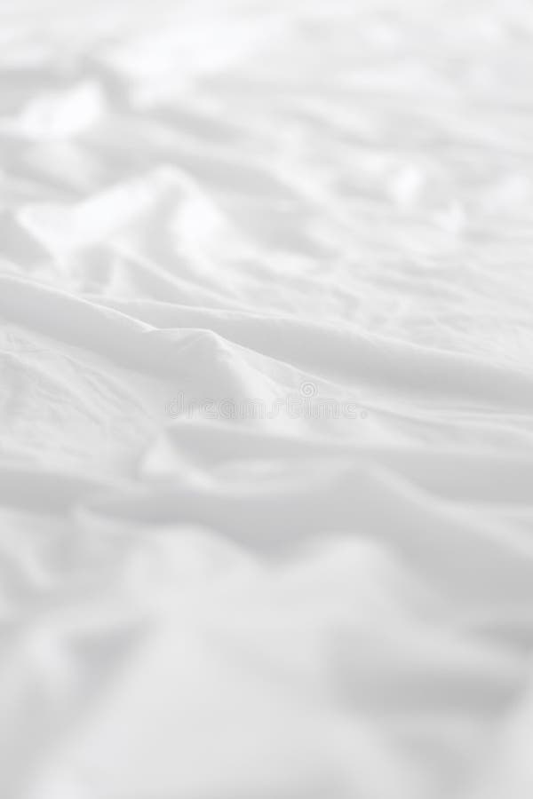 Soft white wrinkle bed sheets for background.