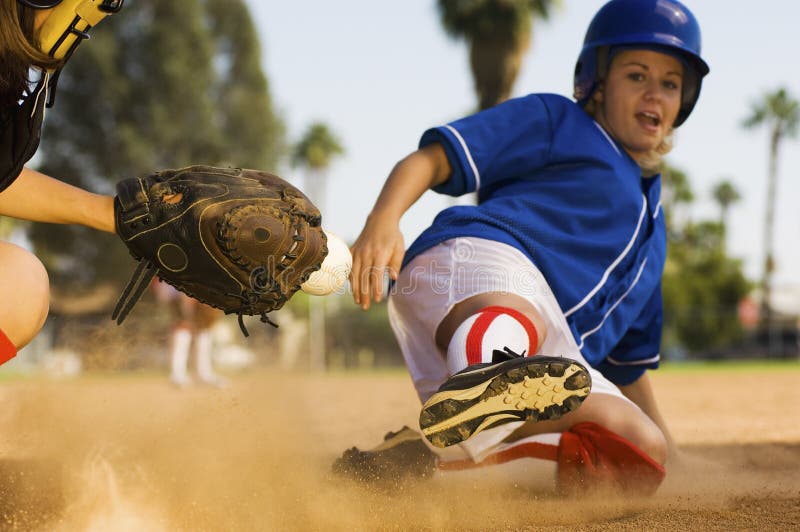 Softball Player Sliding Into Home Plate Stock Image - Image of